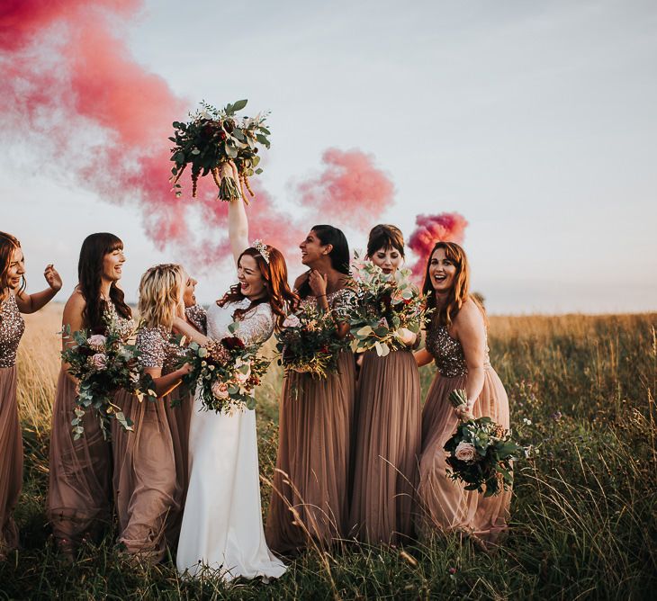 Bridesmaids in sequin dresses with wildflower bouquets