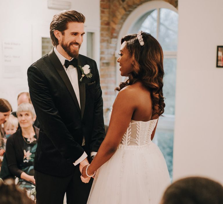 Bride and groom holding hands during Pump House Gallery wedding ceremony