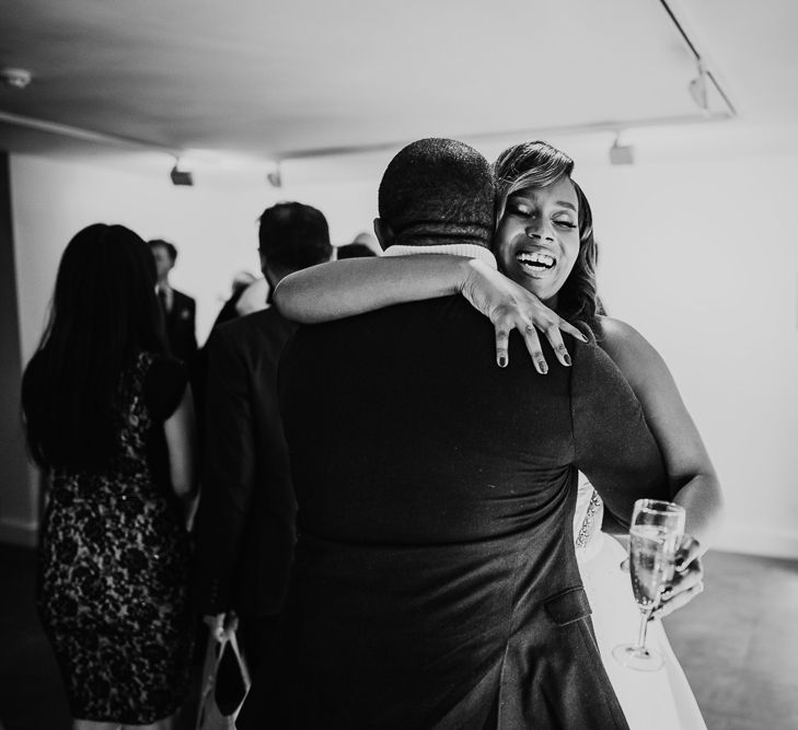 Bride hugging wedding guest