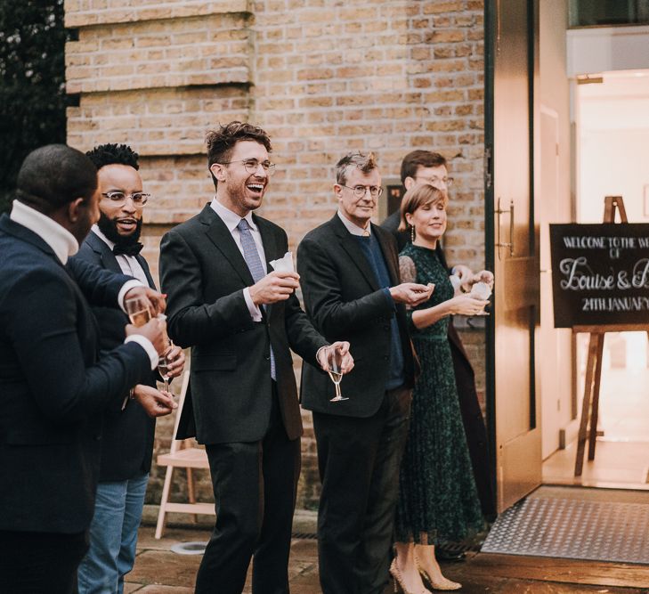 Guests lining up for confetti exit at Pump House Gallery, Battersea Park