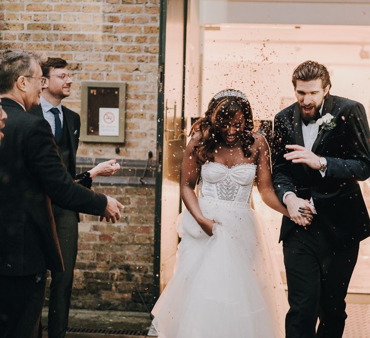 Bride and groom confetti moment outside Pump House Gallery, Battersea Park