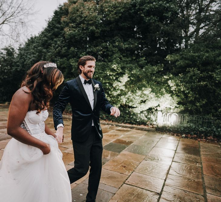 Bride and groom holding hands at Pump House Gallery