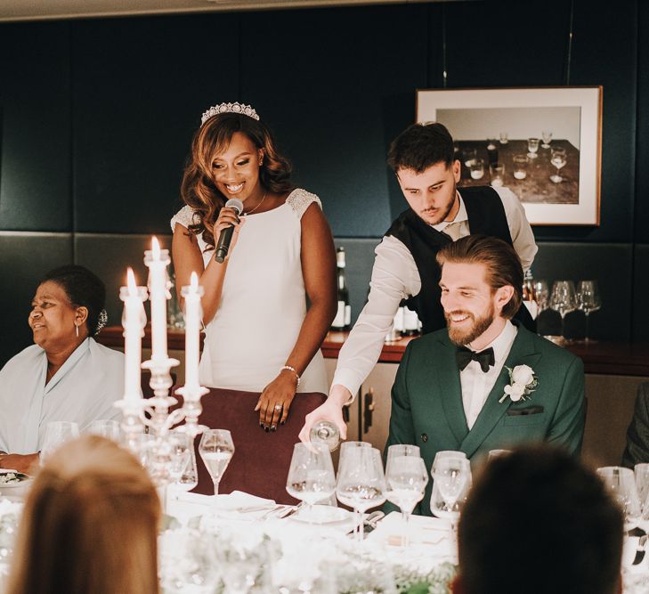 Bride in Pronovias wedding dress and bridal crown giving a speech