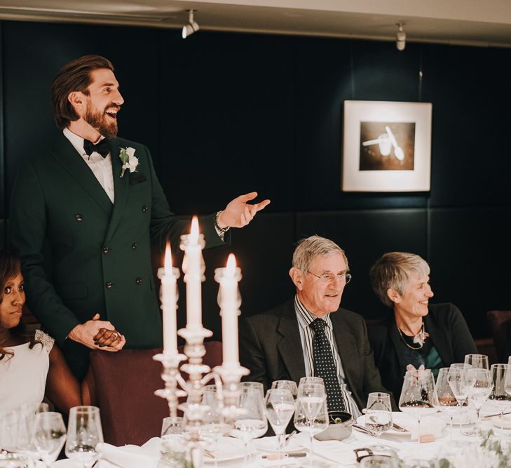 Bride and groom holding hands during wedding speeches