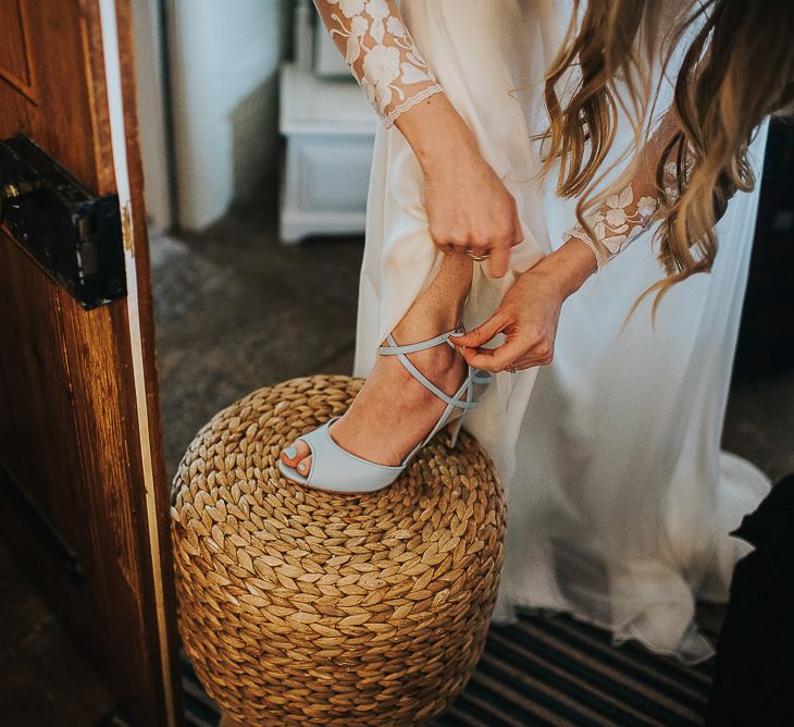 Bride Putting On Charlotte Mills April Blue Shoes