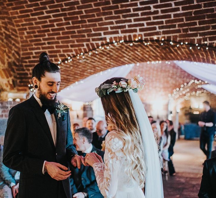 Bride in Catherine Deane Jessica Bodysuit and Anika Skirt Separates  and Groom in Tuxedo Exchanging Wedding Rings