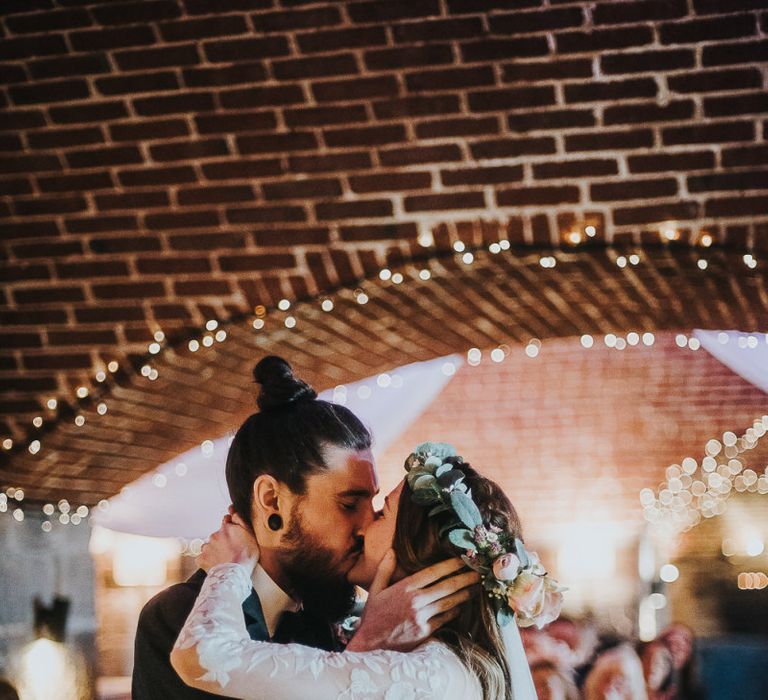 Bride in Catherine Deane Jessica Bodysuit and Anika Skirt Separates  and Groom in Tuxedo Kissing at the Altar