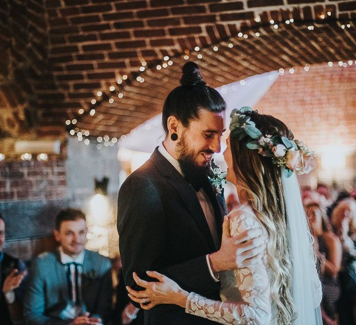 Bride in Catherine Deane Jessica Bodysuit and Anika Skirt Separates  and Groom in Tuxedo Embracing at the Altar