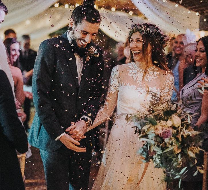 Confetti Moment with Bride in Catherine Deane Jessica Bodysuit and Anika Skirt Separates  and Groom in Tuxedo Walking Up the Altar