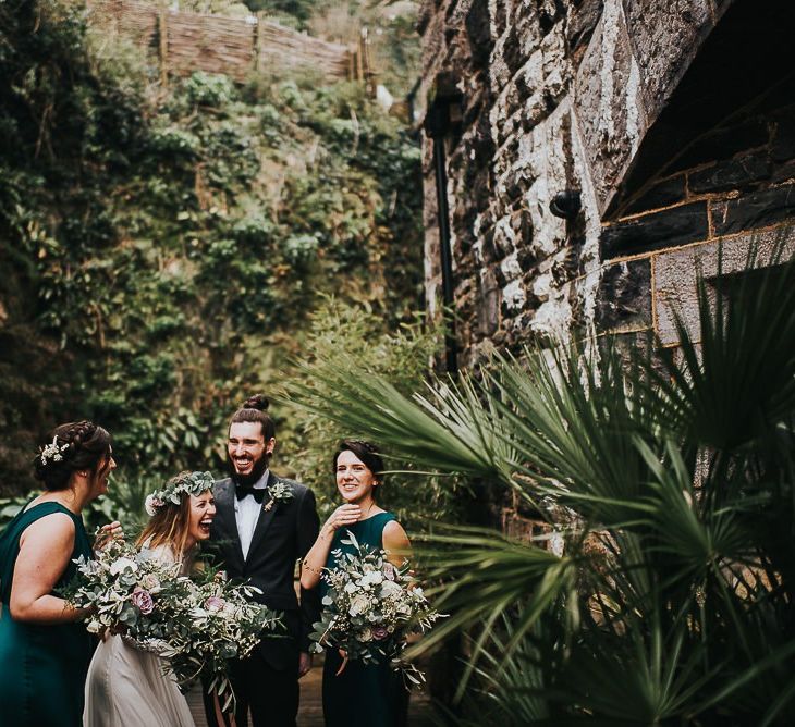 Bride and Groom Laughing With Their Bridesmaids