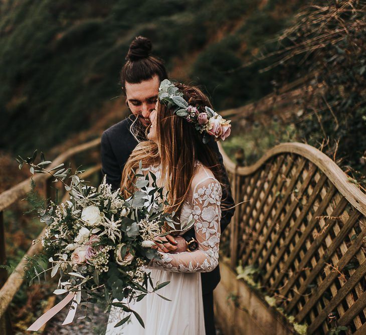 Groom Hugging his Bride in Catherine Deane Separates with Lace Long Sleeves