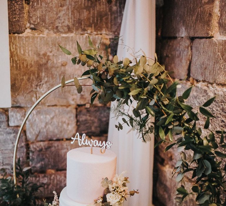 Two Tier White Wedding Cake on Gold Cake Stand with Floral Hoop Decor