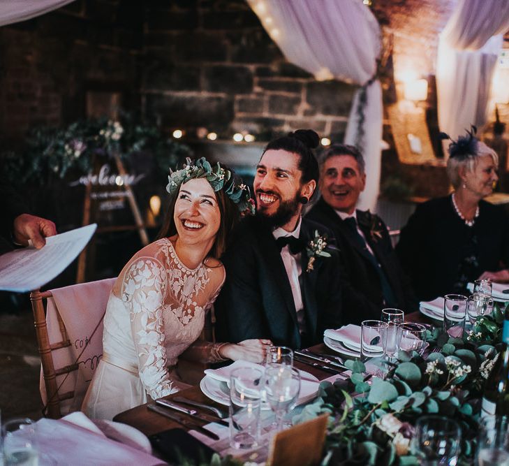 Bride and Groom Smiling During Wedding Reception Speeches