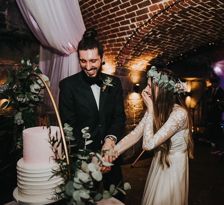 Bride and Groom Cutting The Wedding Cake