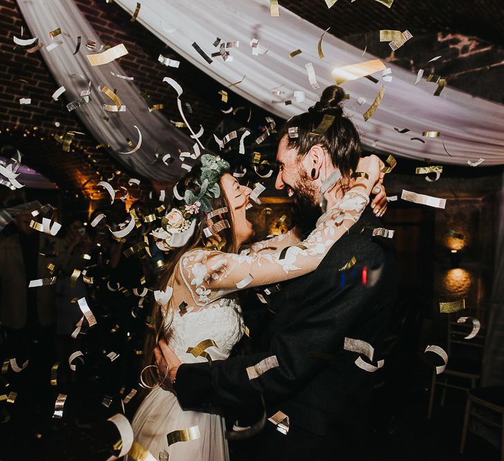 Dance Floor Gold Confetti Bomb Moment with Bride in Catherine Deane Separates and Flower Crown and Groom in Tuxedo