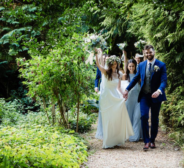 Bride in Charlie Brear Wedding Dress and Groom in Navy Ted Baker Suit