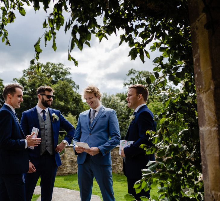 Groomsmen in Navy Blue Suits Standing Outside the Church