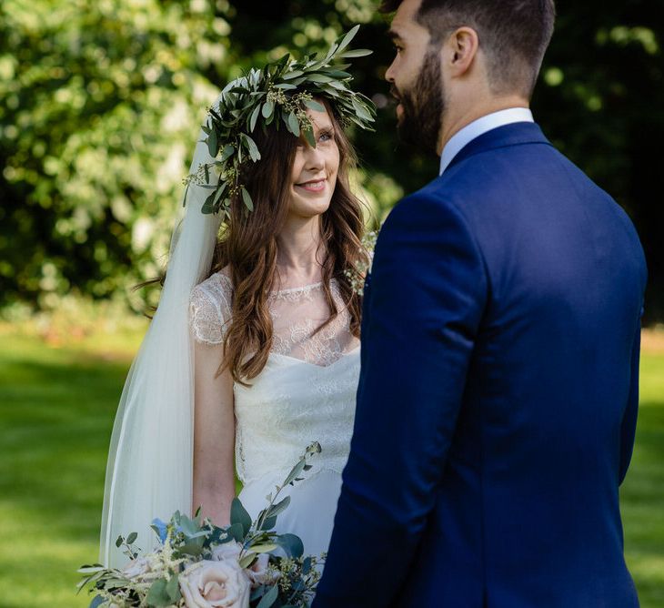 Bride in Charlie Brear Wedding Dress and Olive Flower Crown with Groom in Ted Baker Navy Suit