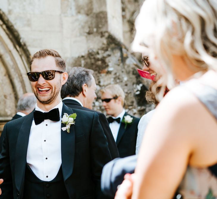 Groom in Black Tie Suit from Charles Tyrwhitt in the Church Courtyard