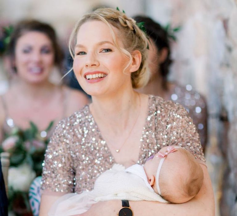 Beautiful bridesmaid with baby