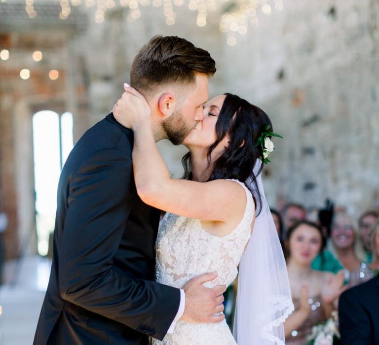 Bride and groom kiss at Lulworth Castle wedding