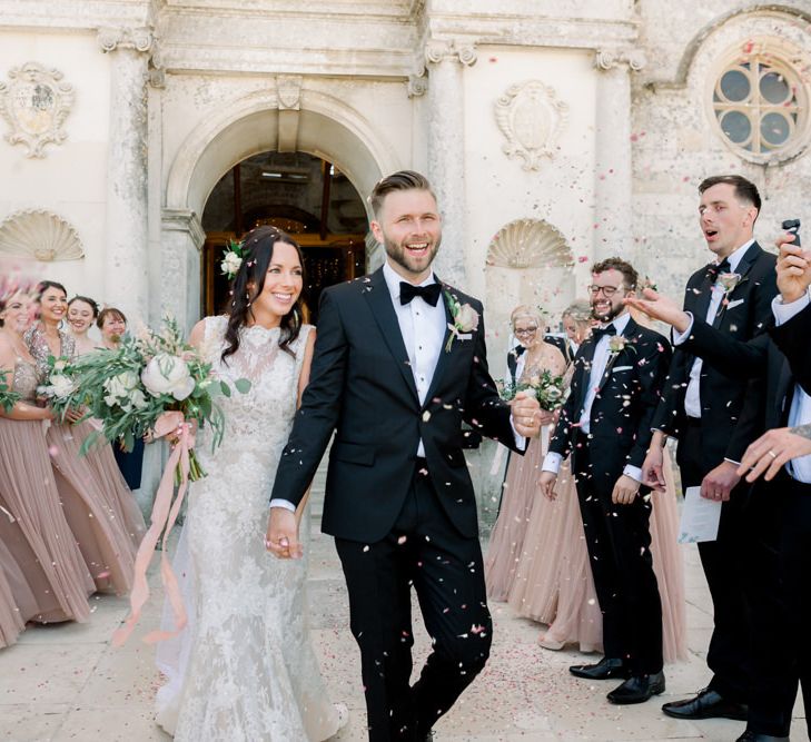 Confetti exit for bride and groom at Lulworth Castle wedding