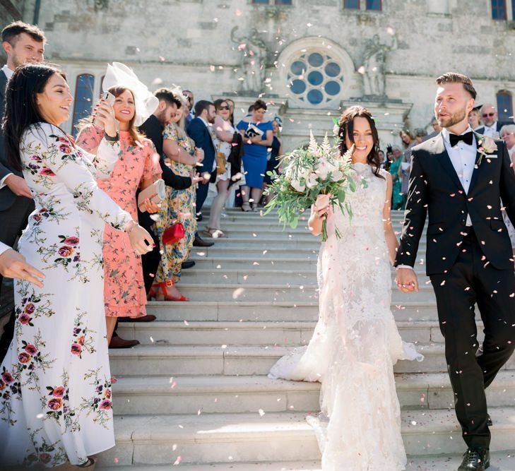 Confetti exit for bride and groom at Lulworth Castle wedding