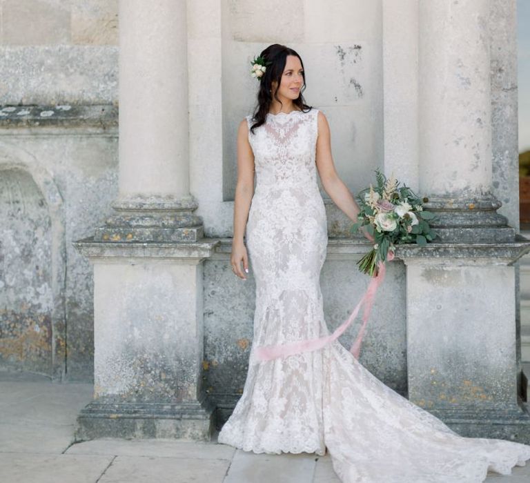 Beautiful bride in lace wedding dress with flower hairpiece