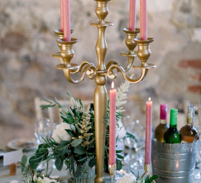 Pink candles in gold candelabra