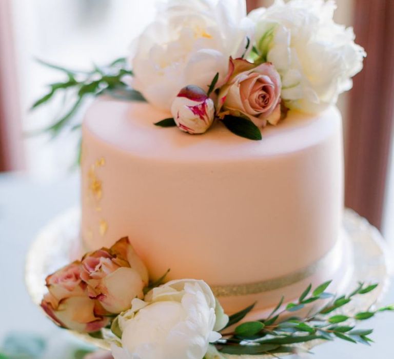 Pink wedding cake with flower decor