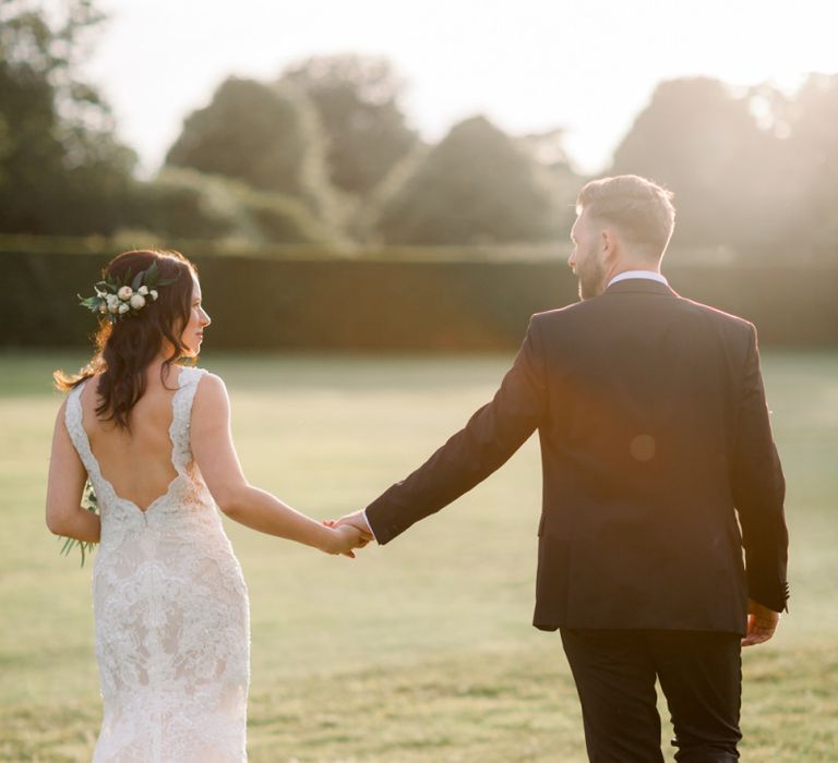 Low back lace wedding dress with floral hairpiece