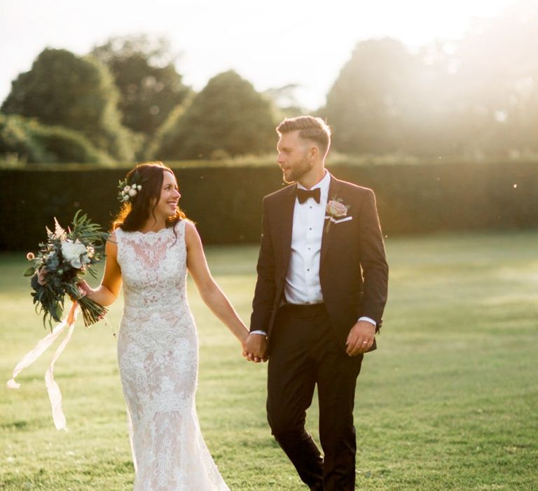 Lace wedding dress and black tuxedo for Lulworth Castle wedding