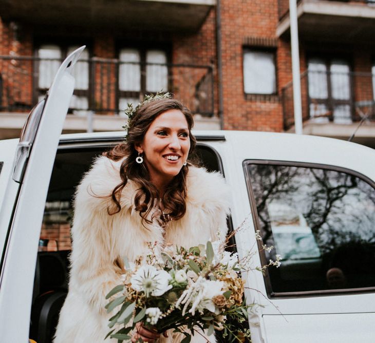 Bride Arriving in a White Cab in Grace Loves Lace Wedding Dress and Faux Fur Coat