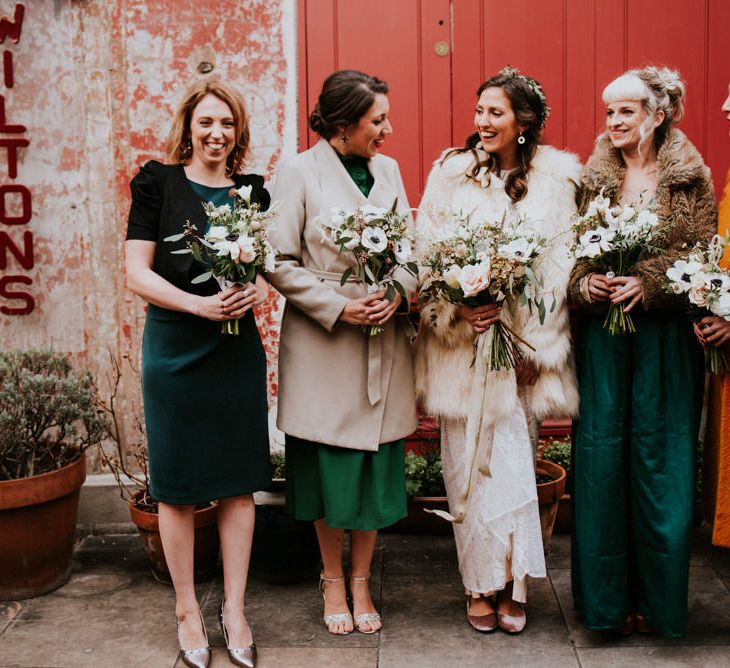 Bridal Party in Their Own Forest Green Dresses and Winter Coats and Bride in Grace Loves Lace Wedding Dress