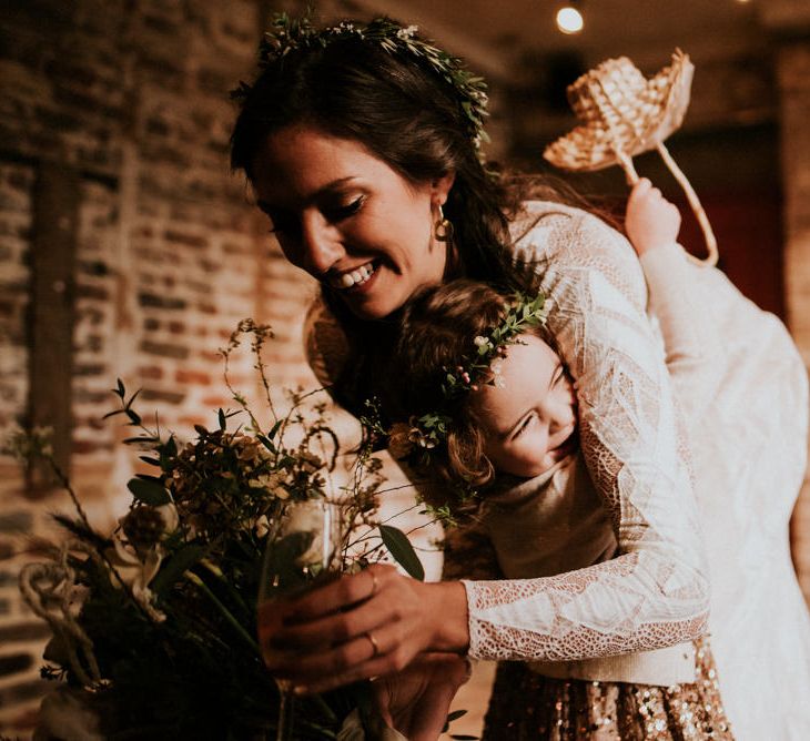 Bride in Grace Loves Lace Wedding Dress with Long Sleeves Hugging Flower Girl