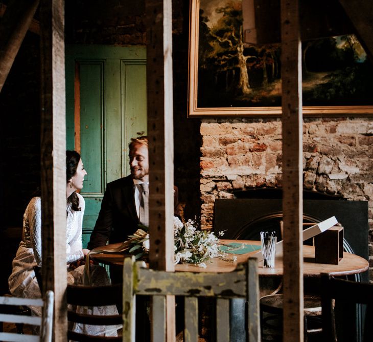 Portrait of Bride in Grace Loves Lace Wedding Dress and Groom in Dark Suit  at Wilton's Music Hall