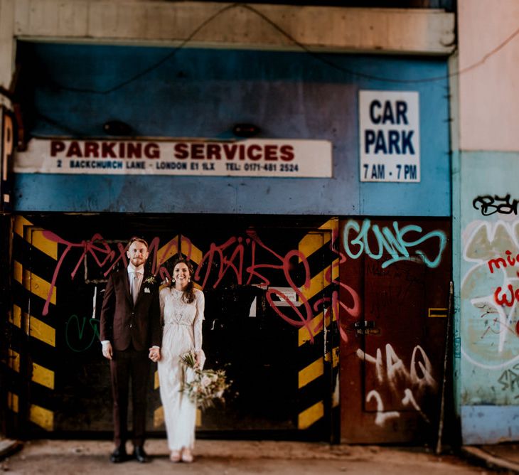 Portrait of Bride in Grace Loves Lace Wedding Dress and Groom in Dark Suit  in Urban London