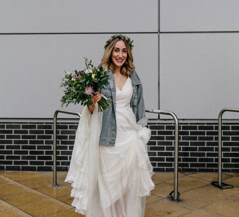 Stylish bride in Catherine Deane wedding dress and denim jacket