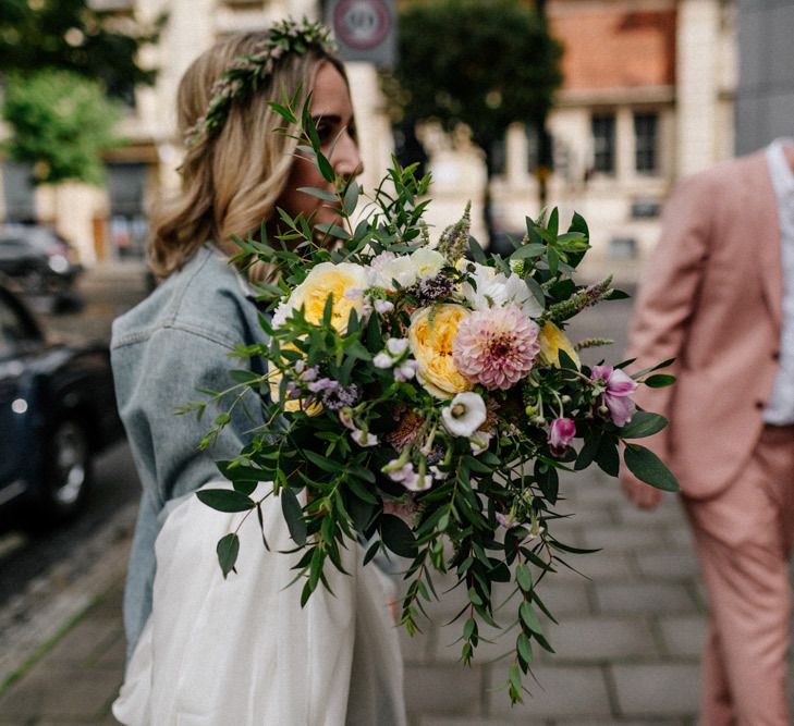 Wedding bouquet with pink dahlias, yellow roses and foliage