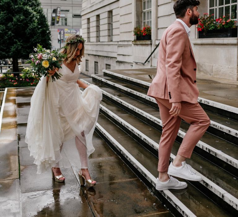 Bride and groom walking up the steps to their Hackney Town Hall micro wedding