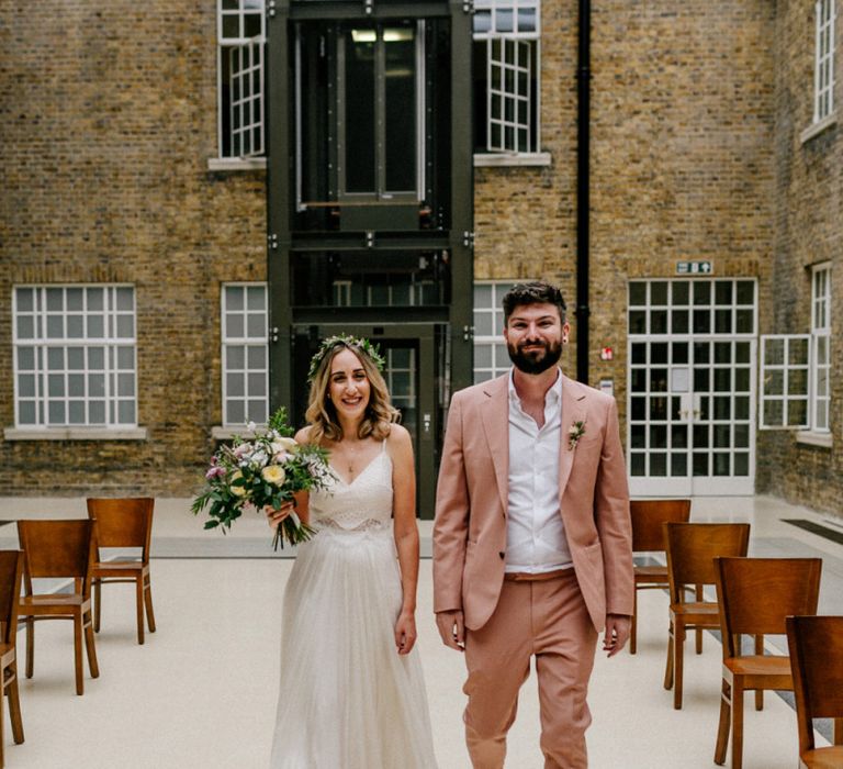 Bride and groom walking down the aisle together