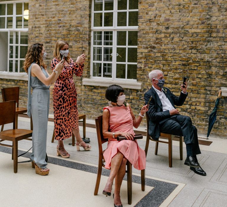 Wedding guests with masks on at 2020 wedding at Hackney Town Hall