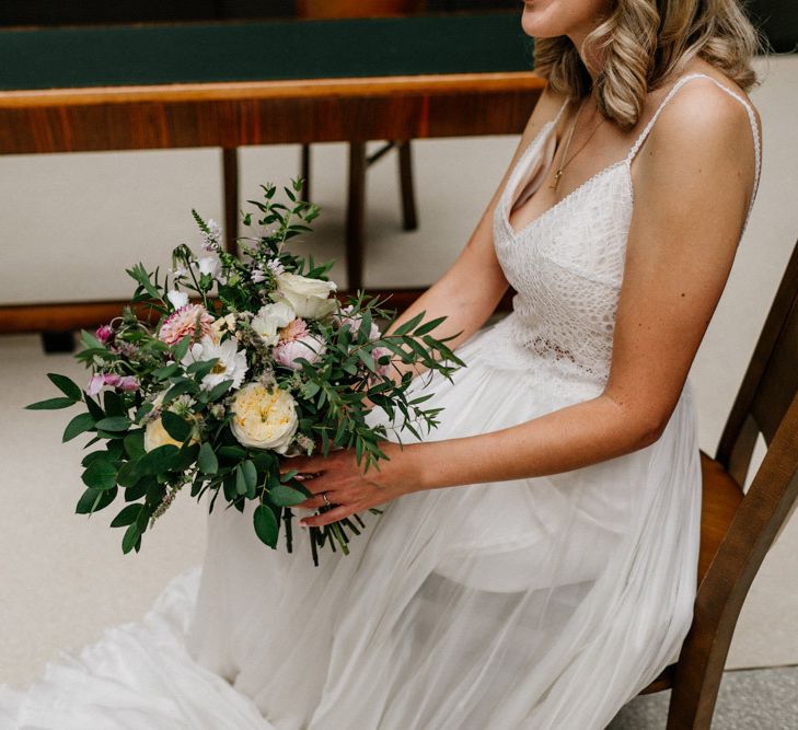 Bride in Catherine Deane wedding dress holding her bridal bouquet