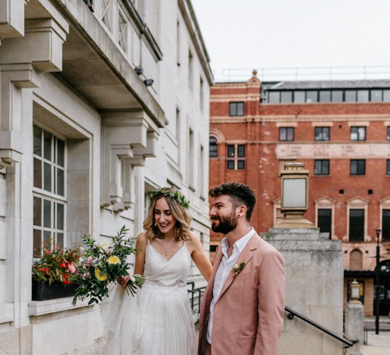 Bride and groom on the steps of Hackney Town Hall just married