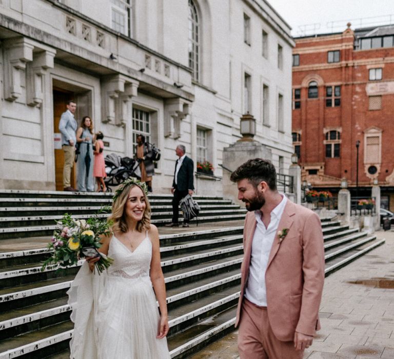 Boho bride in Catherine Deane wedding dress and groom in coloured suit at intimate city wedding