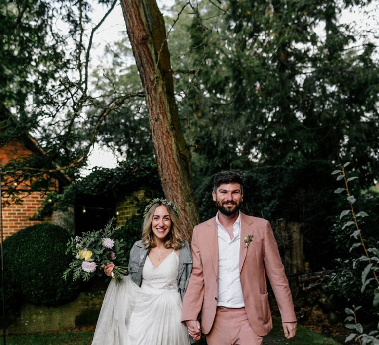 Boho bride in Catherine Deane wedding dress and groom in blush suit