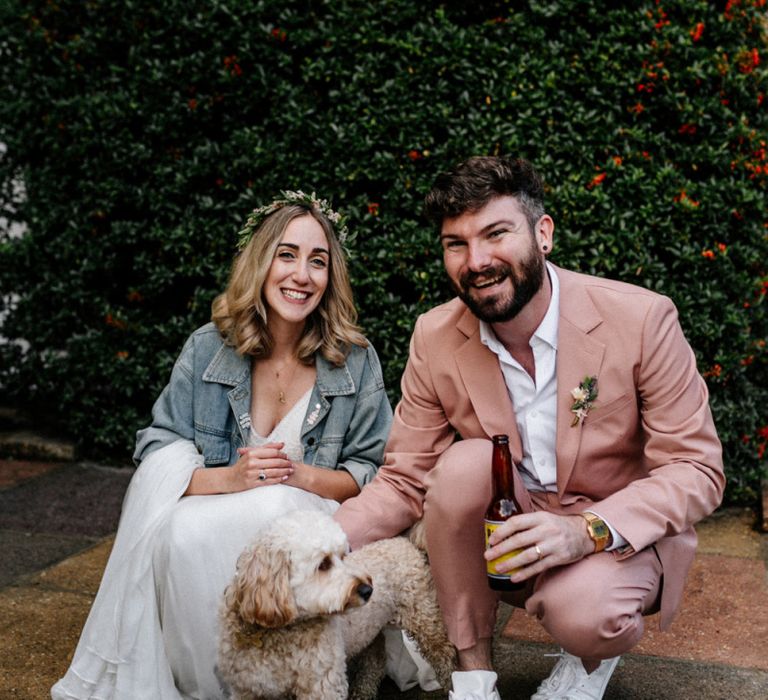 Bride and groom portrait with their pet dog