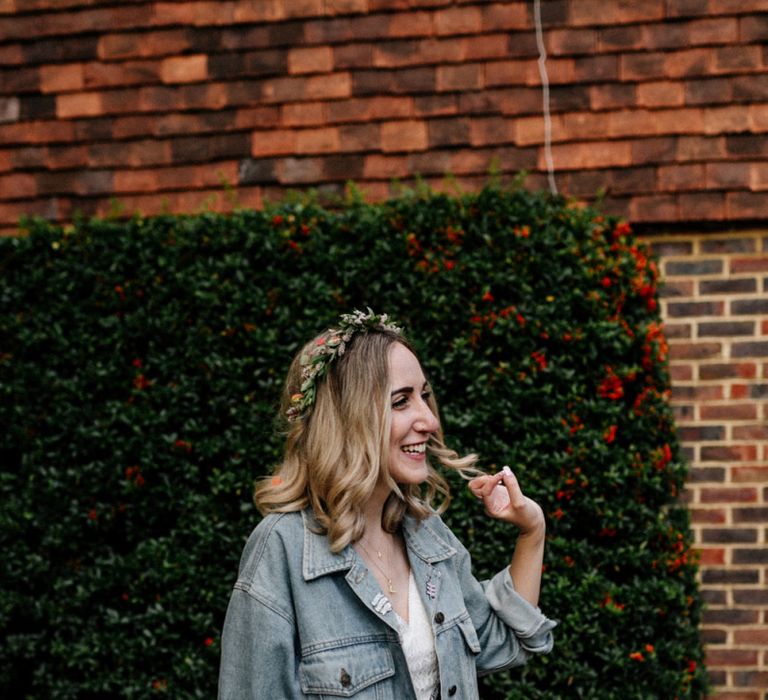 Stylish bride in relaxed denim jacket and flower crown