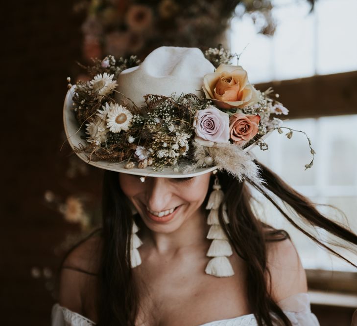 Boho Bride Wearing Cowboy Hat Decorated with Dried Flowers