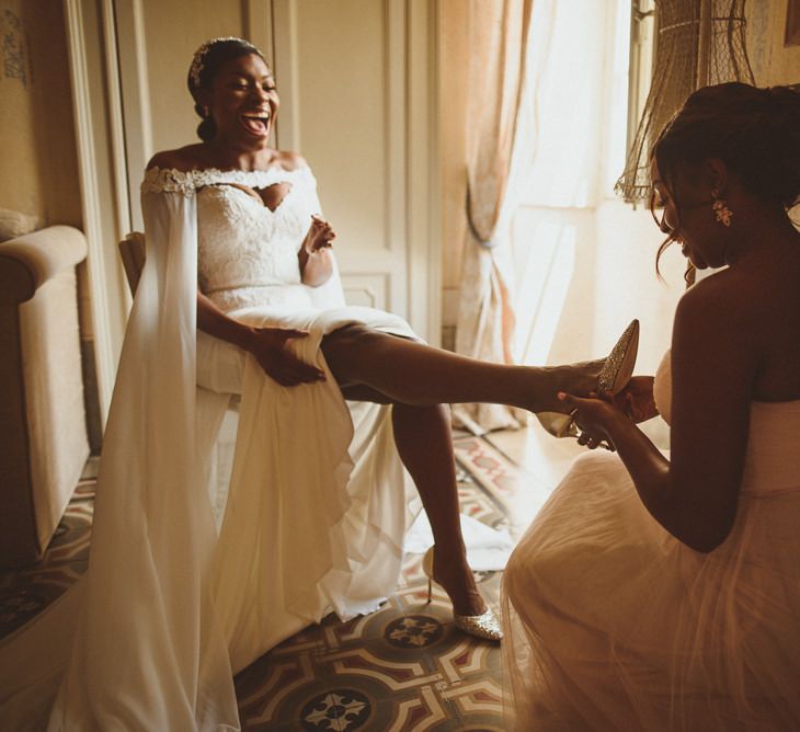 Bride putting on her wedding shoes